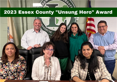  unsung hero award winner poses with members of the board of education